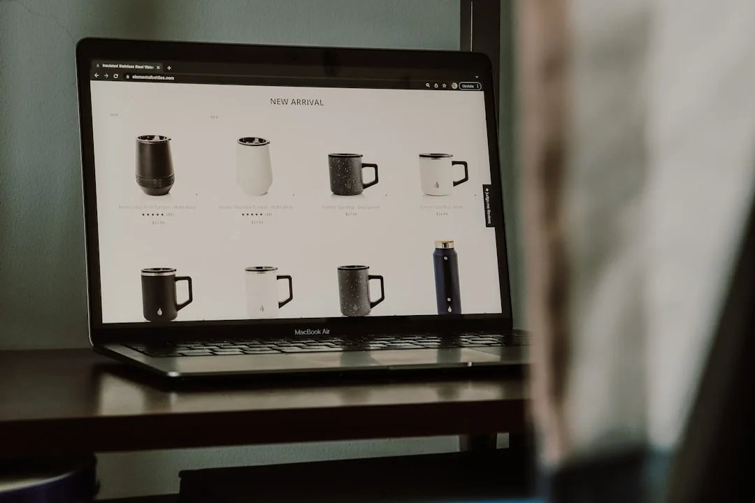 A modern workspace featuring dual computer monitors displaying web design projects, emphasizing technology and productivity.
